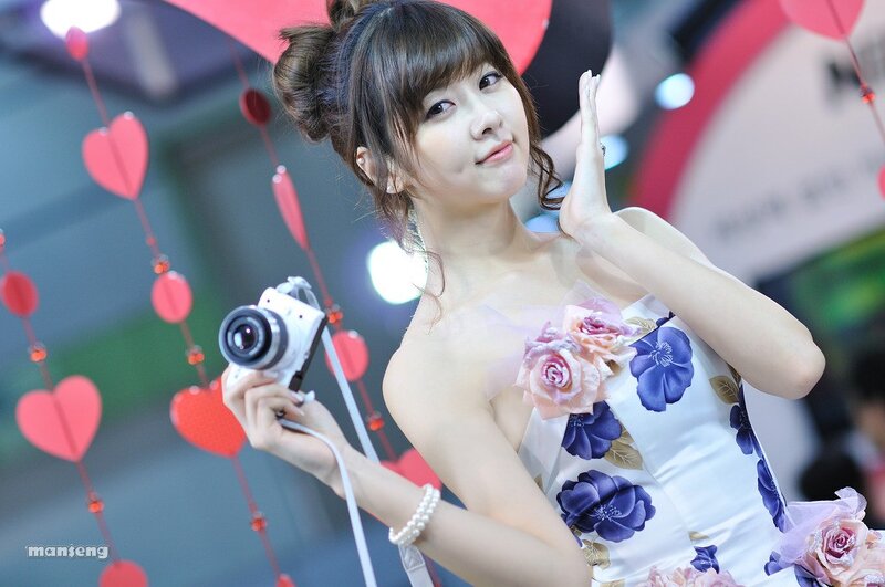 Woman holding camera at event