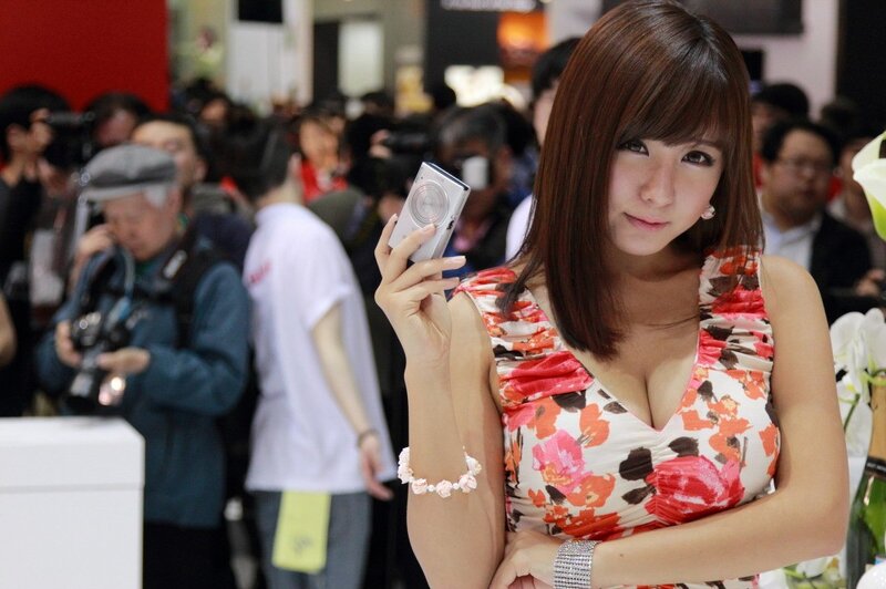 Woman holding camera at event
