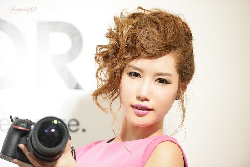 woman holding camera at event