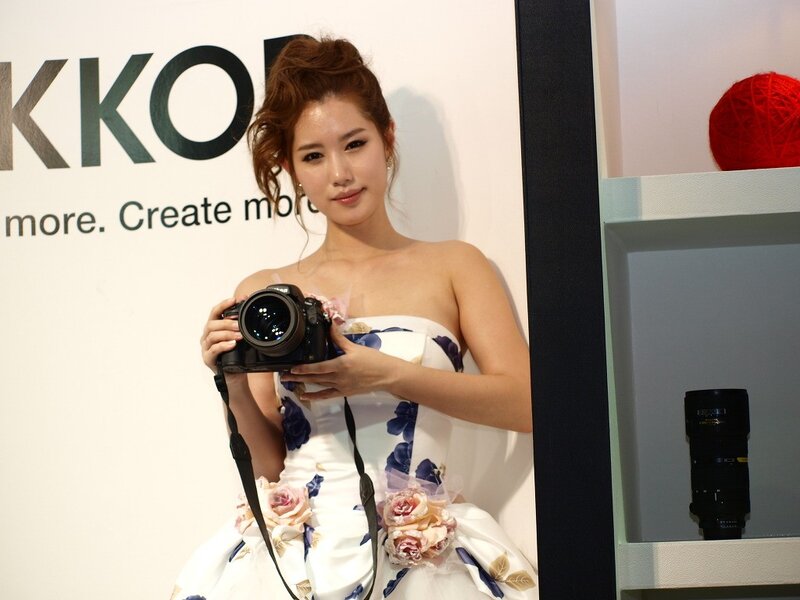 Woman holding camera at event
