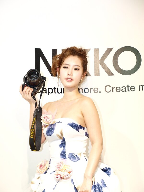 Woman holding camera at event