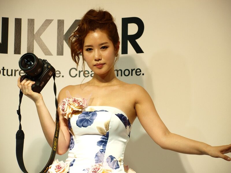 Woman holding camera at event