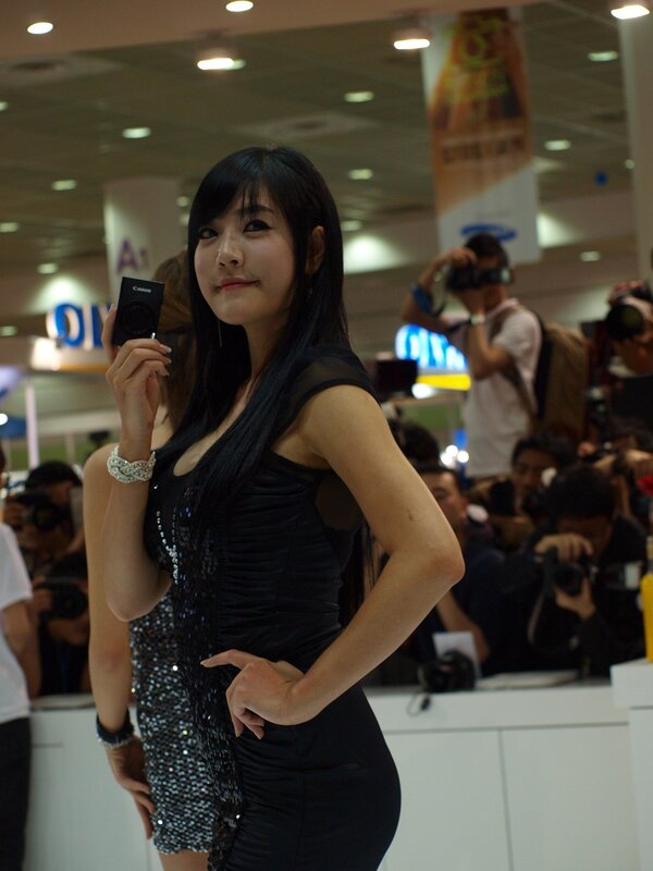 Woman holding camera at event
