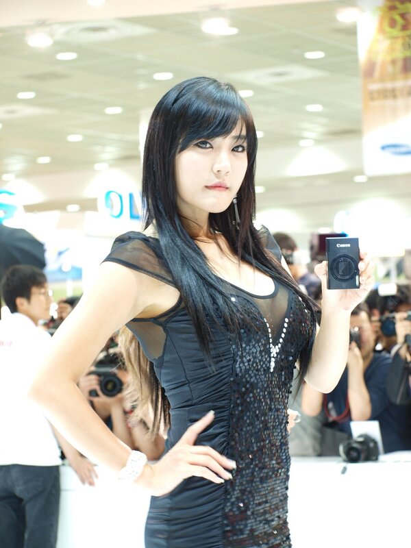 Woman holding camera at event
