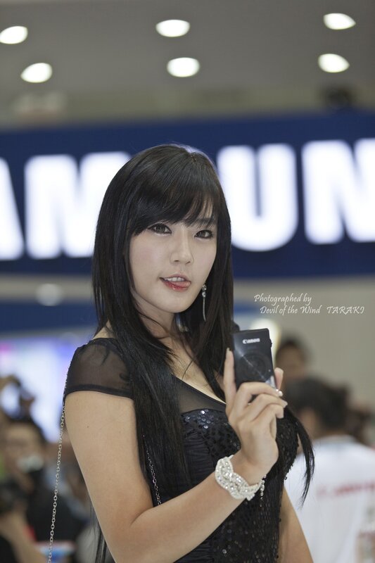 Woman holding camera at event