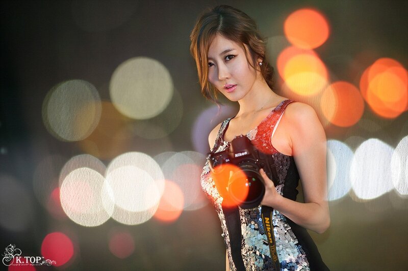 woman holding camera at night