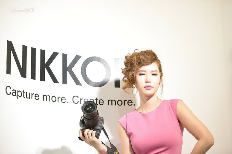 Woman holding camera at Nikon event