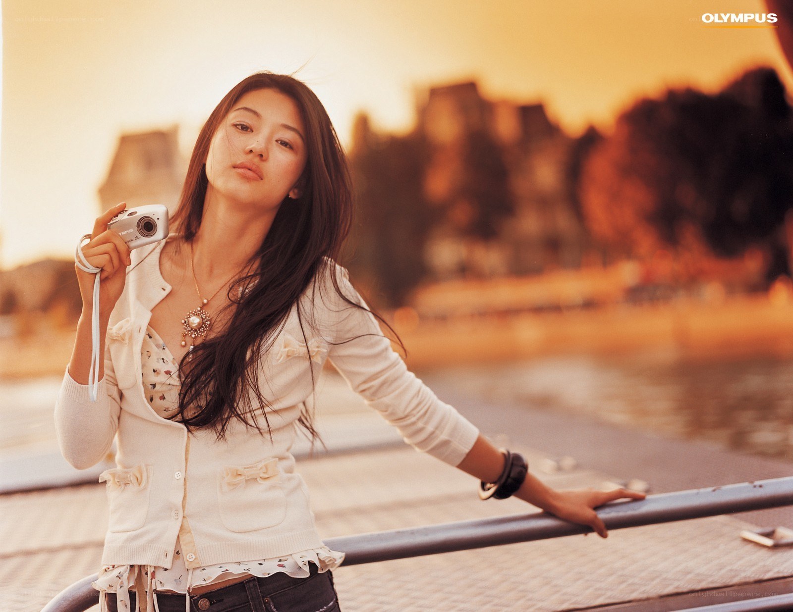 woman holding camera at sunset