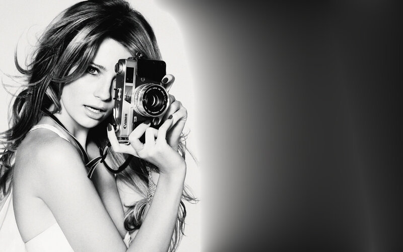 Woman Holding Camera — Black, Dramatic, Photograph, Hair, White Top