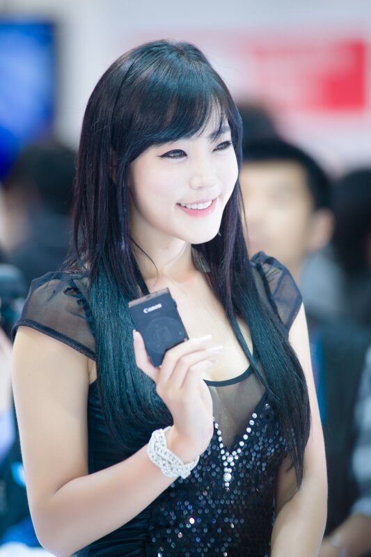 Woman Holding Camera — Black, Smiling