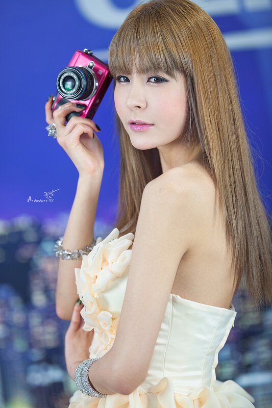 Woman Holding Camera — Blue, Confident