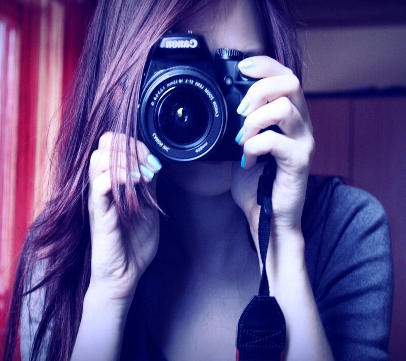 Woman Holding Camera — Blue, Dramatic