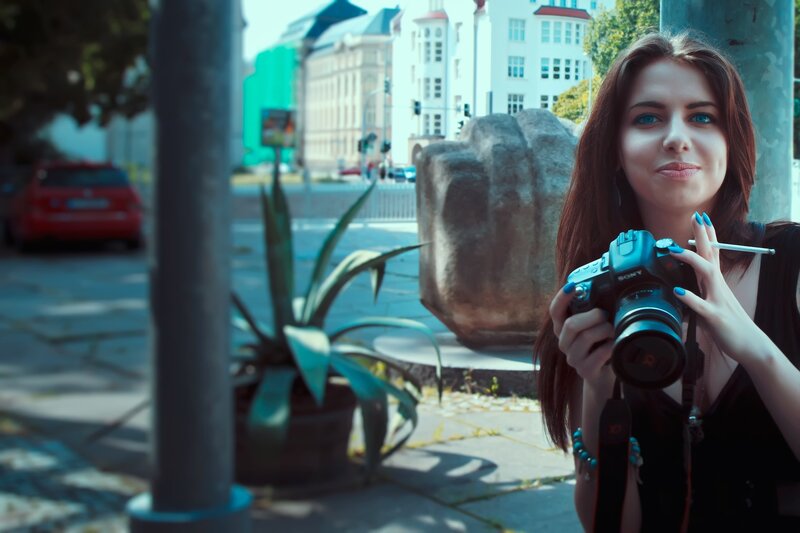 Woman Holding Camera — Blue, Urban