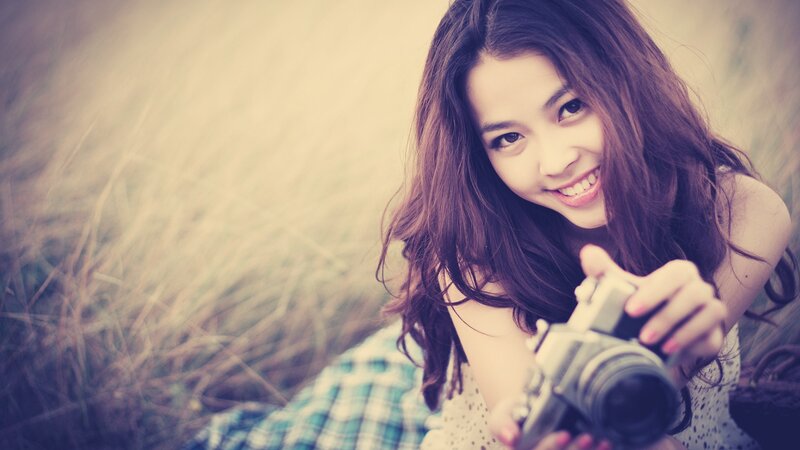 Woman Holding Camera — Brown, Calm, Afternoon, Photograph, Grass, Plaid Shirt