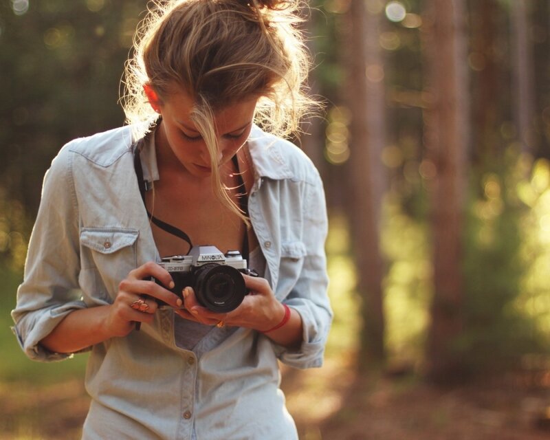 Woman Holding Camera — Brown, Serene
