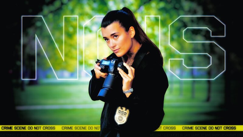 Woman Holding Camera — Green, Serious