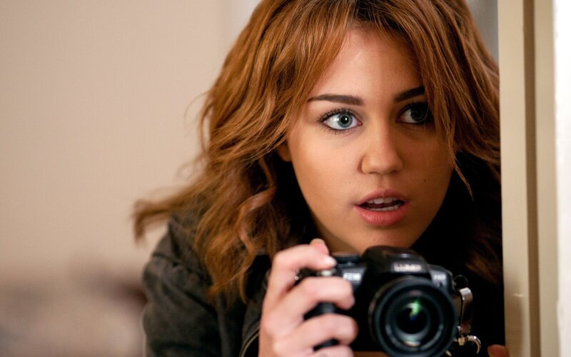 woman holding camera in hallway