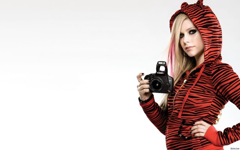 woman holding camera in hoodie