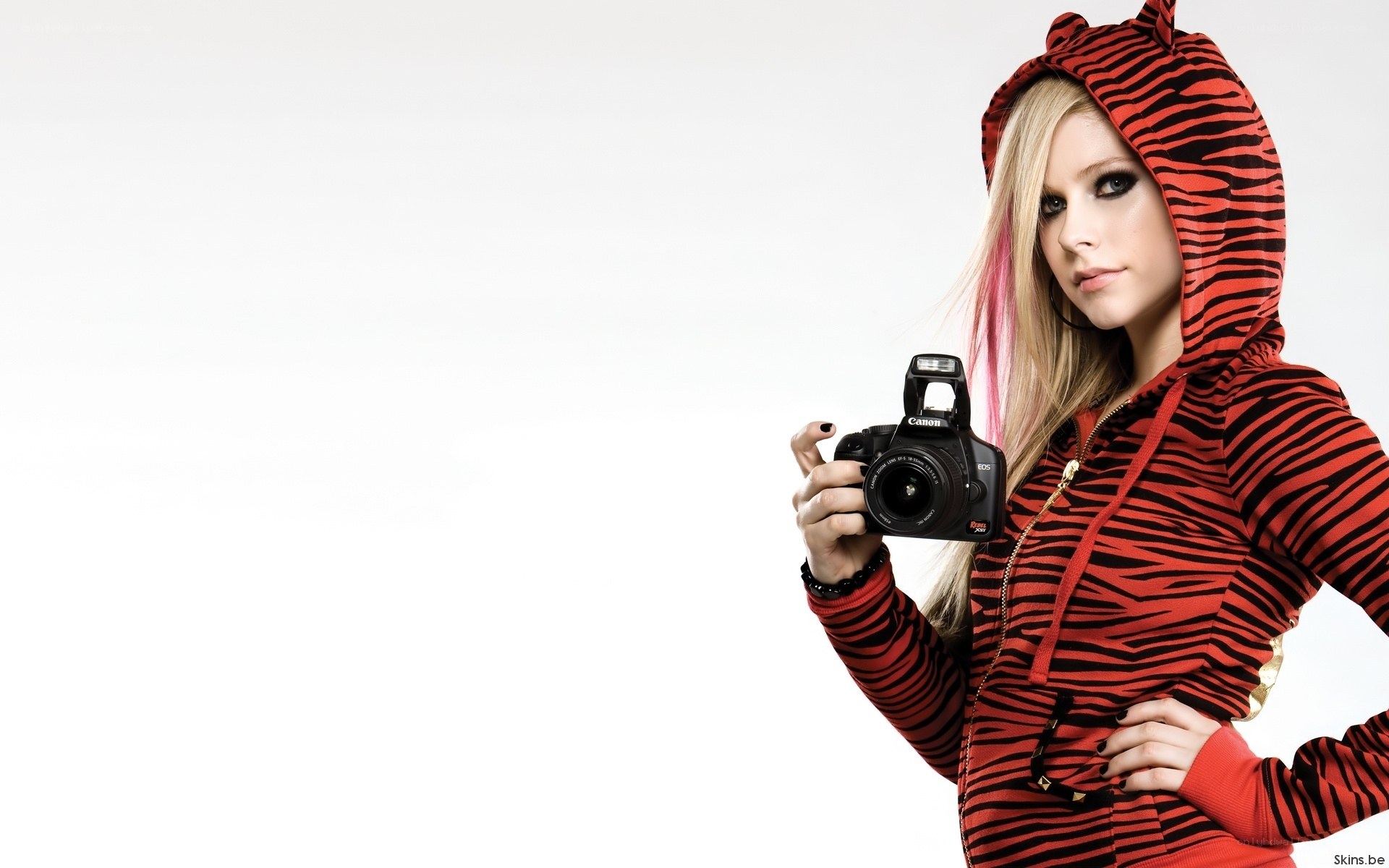 woman holding camera in hoodie