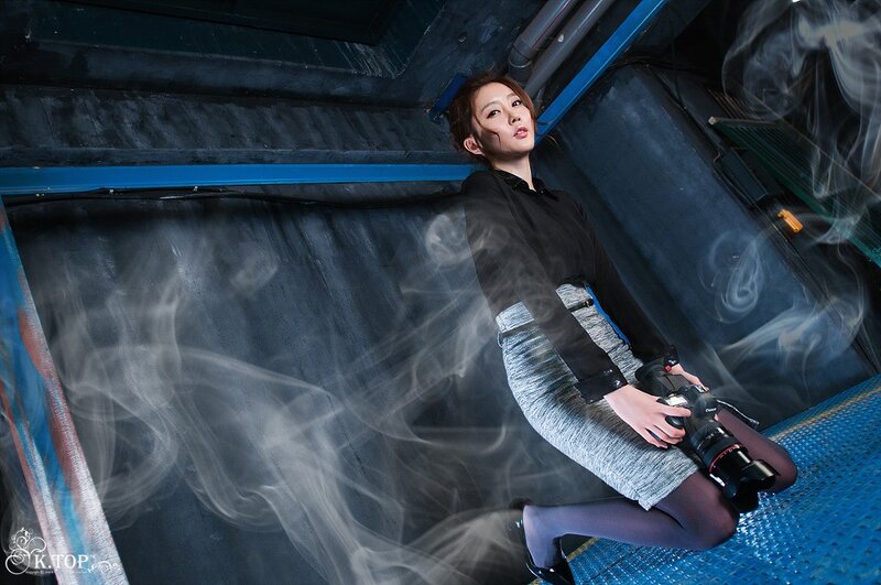woman holding camera in industrial setting