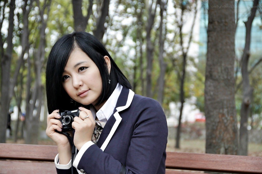 woman holding camera in park