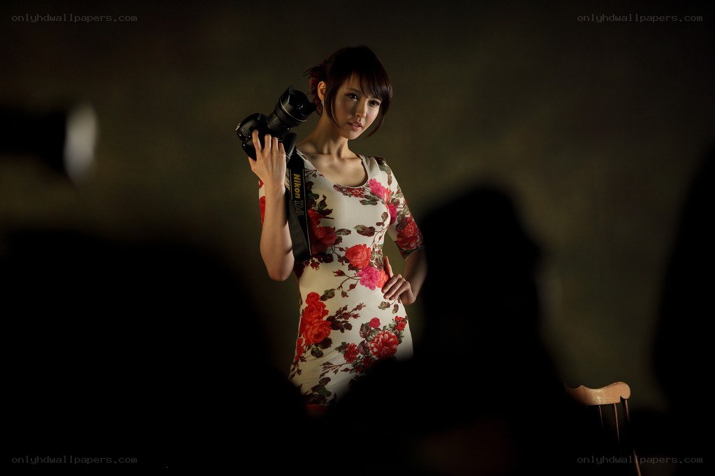 woman holding camera in studio