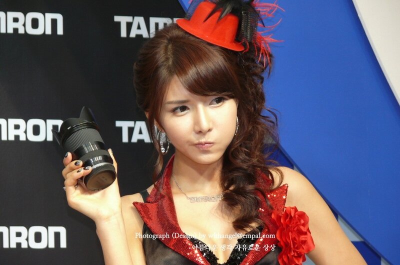 Woman holding camera lens at event