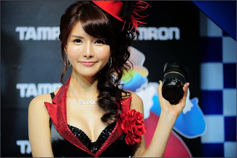 Woman holding camera lens at event