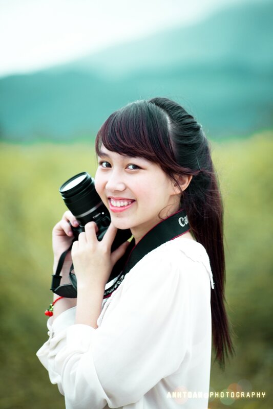 Woman holding camera outdoors