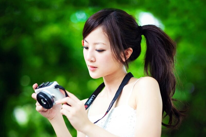 woman holding camera outdoors