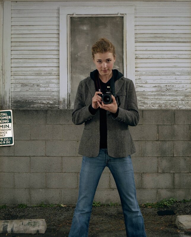 woman holding camera outdoors