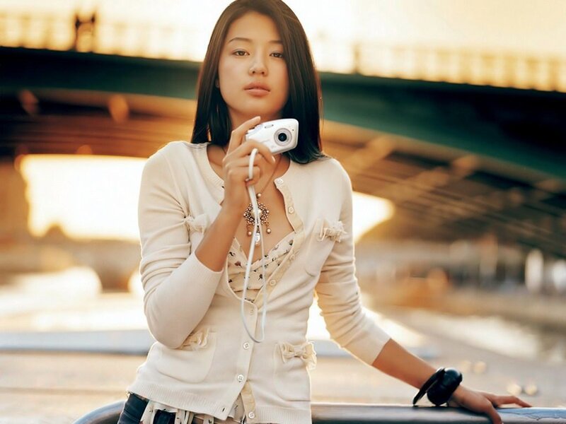 woman holding camera outdoors