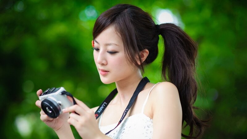 woman holding camera outdoors
