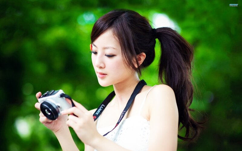 woman holding camera outdoors