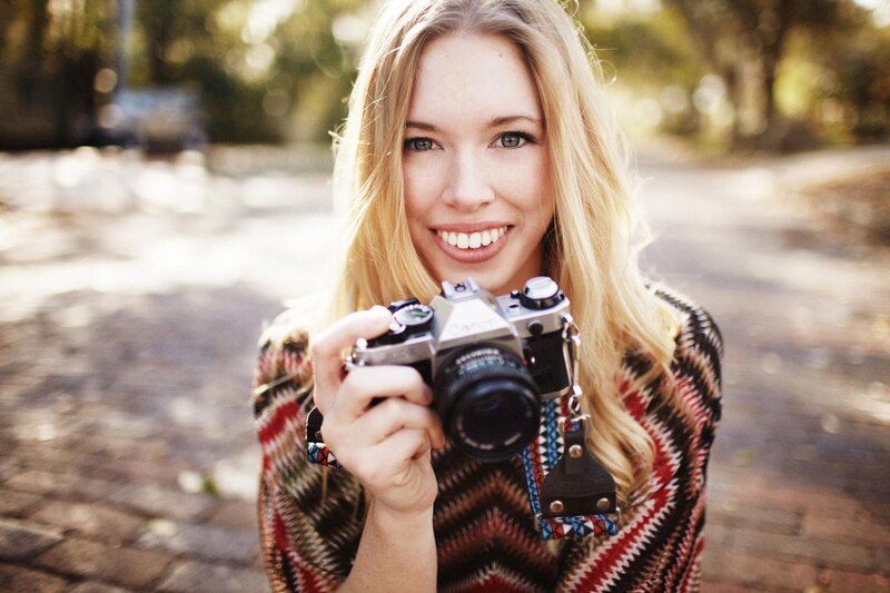woman holding camera outdoors