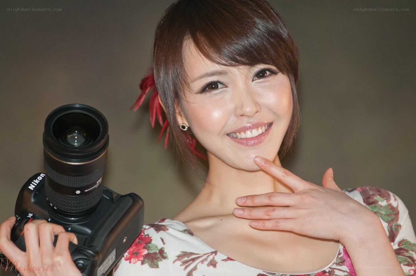 Woman holding camera smiling