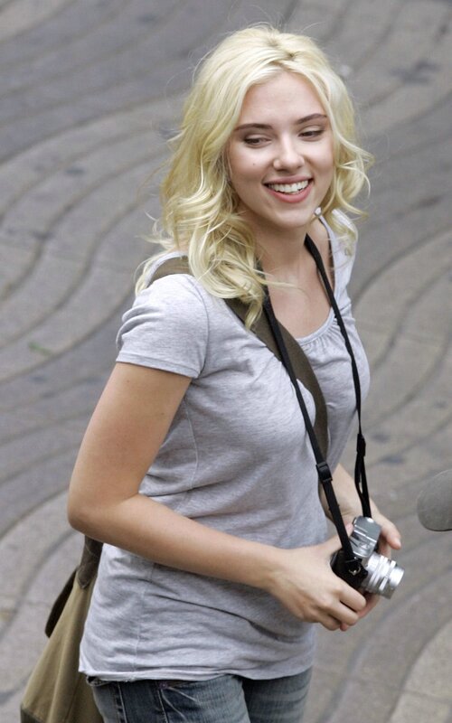 woman holding camera smiling