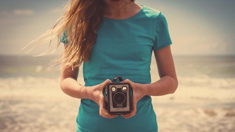 Woman Holding Camera — Teal