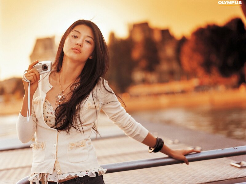 Woman Holding Camera — White, Calm, Sunset