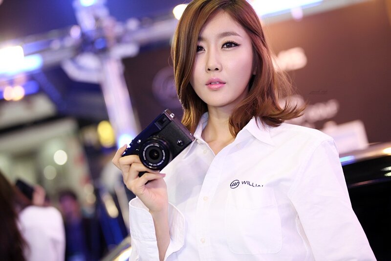 Woman Holding Camera — White, Neutral, Night