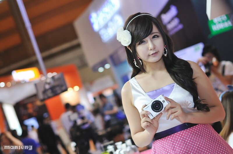 Woman Holding Camera — White, Neutral, Photograph, Headband
