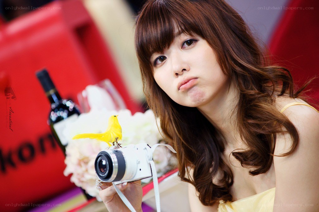 woman holding camera with bird