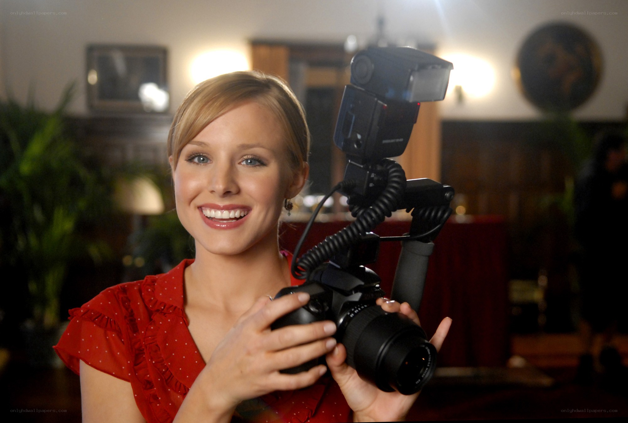 Woman holding camera with flash