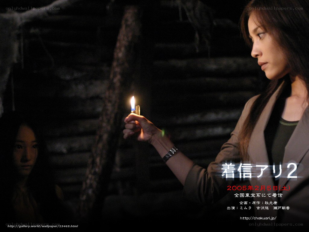 Woman holding candle in dark room