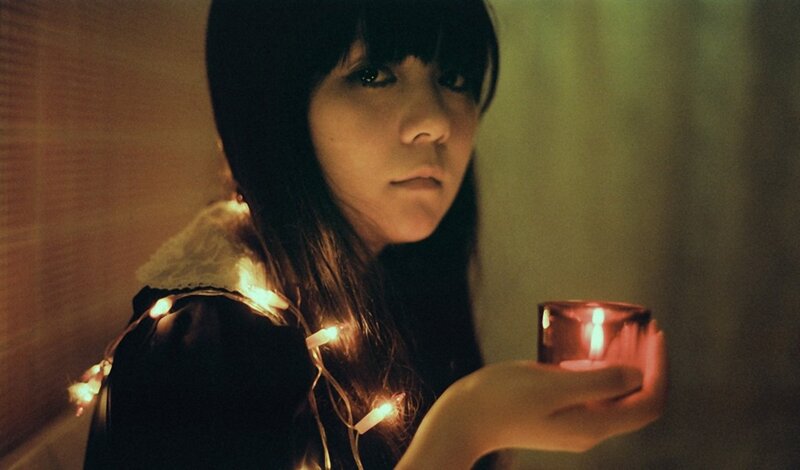 woman holding candle in dim light