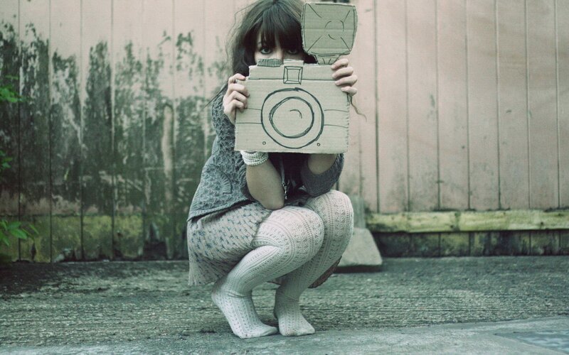 woman holding cardboard camera