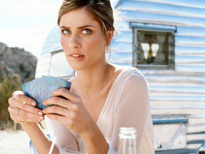 Woman holding cards outdoors