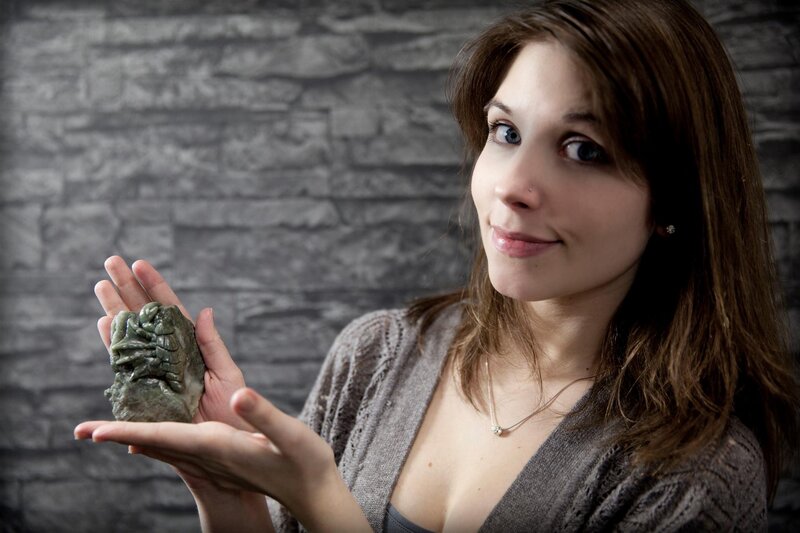 woman holding carved stone