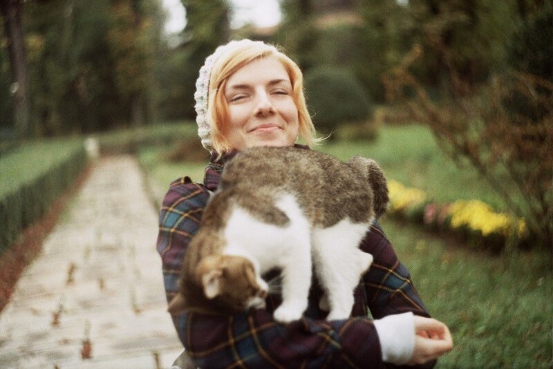 Woman holding cat in garden