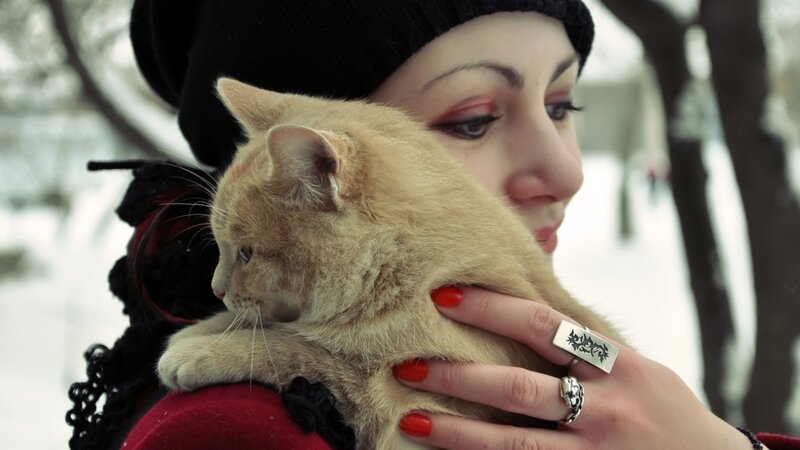 woman holding cat in winter